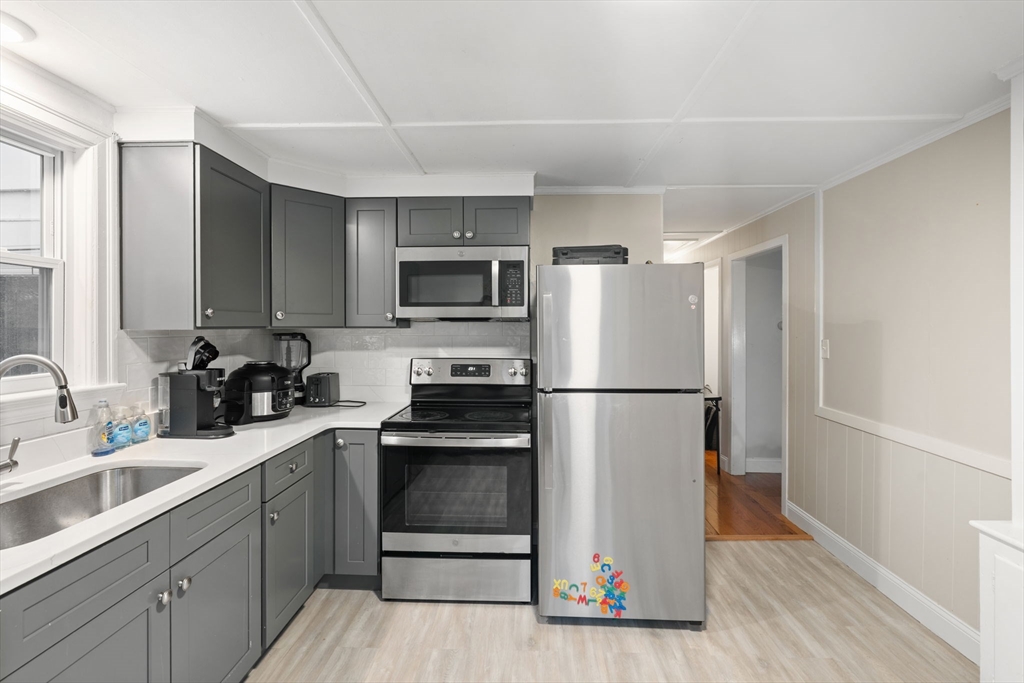 19 Cedar Street Beverly, MA 01915 - Photo 12 of 33 a kitchen with a refrigerator stove and sink