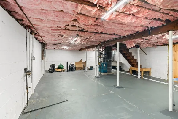 a view of a big room with stairs and washing machine