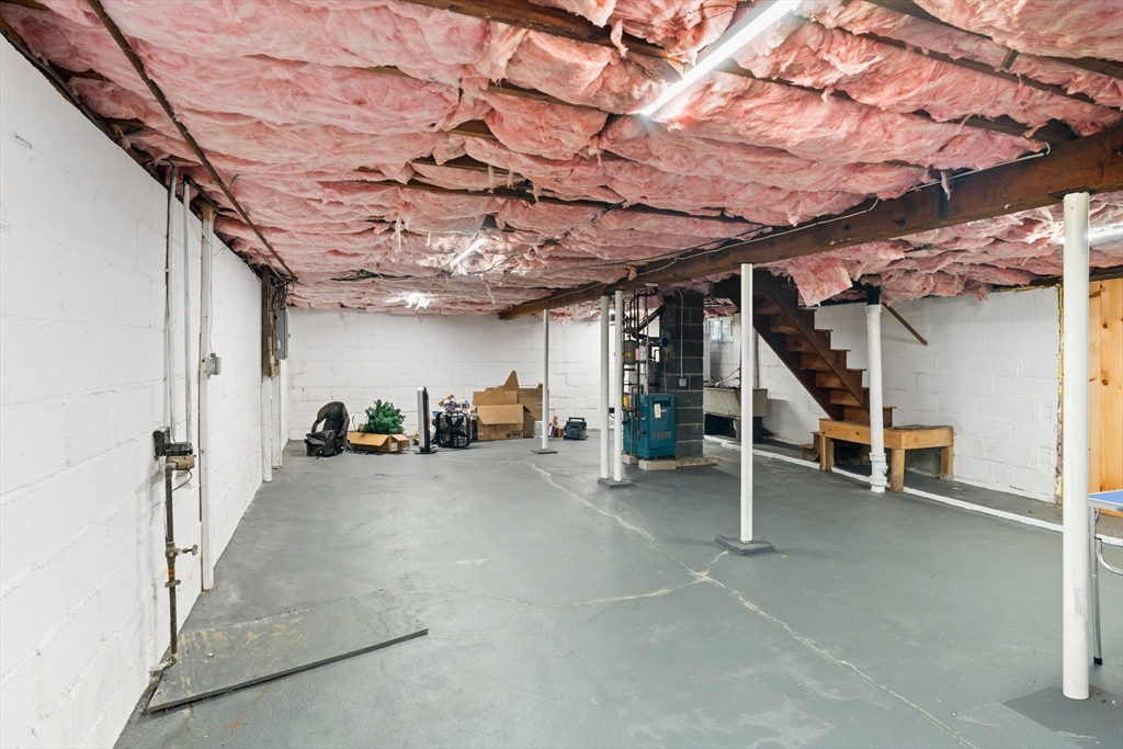 19 Cedar Street Beverly, MA 01915 - Photo 26 of 33 a view of a big room with stairs and washing machine