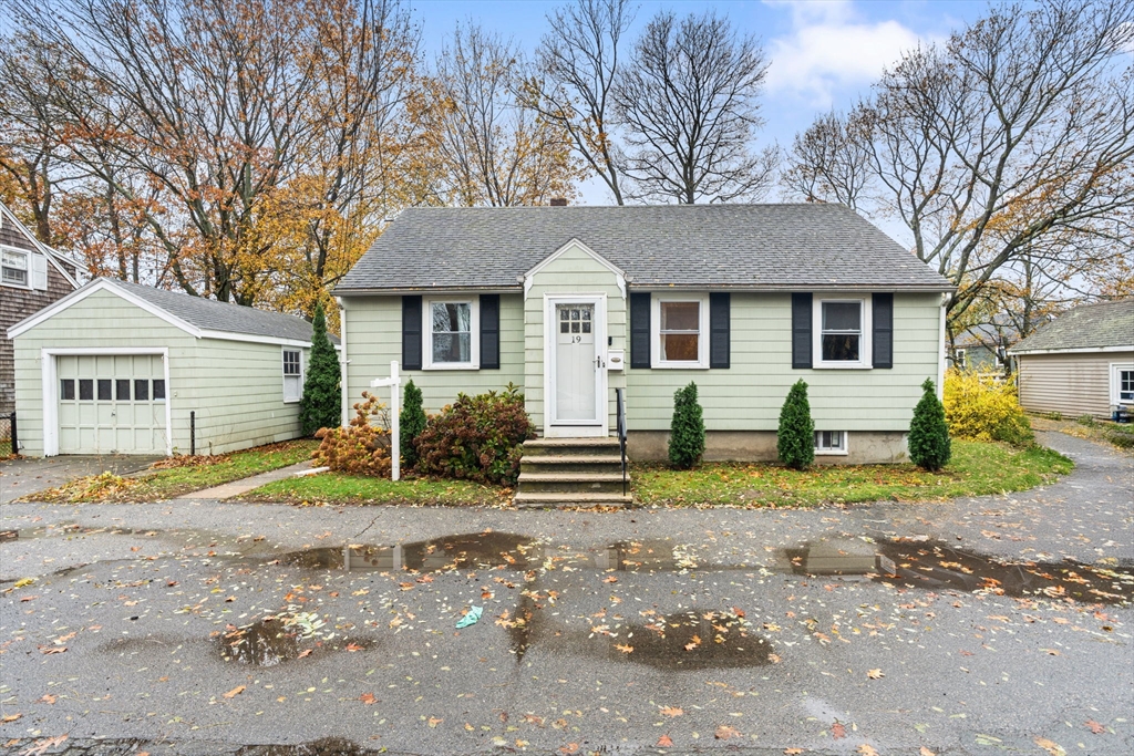 19 Cedar Street Beverly, MA 01915 - Photo 29 of 33 a front view of a house with a yard and garage