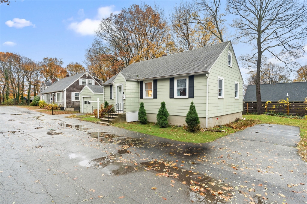 19 Cedar Street Beverly, MA 01915 - Photo 31 of 33 a view of a white house with a big yard and large trees