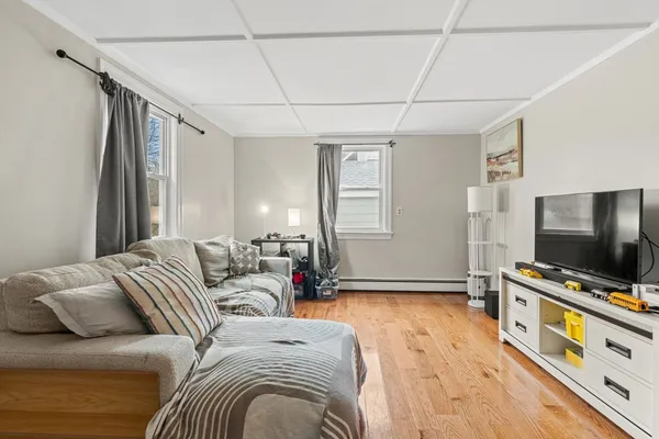 a bedroom with furniture and a flat screen tv