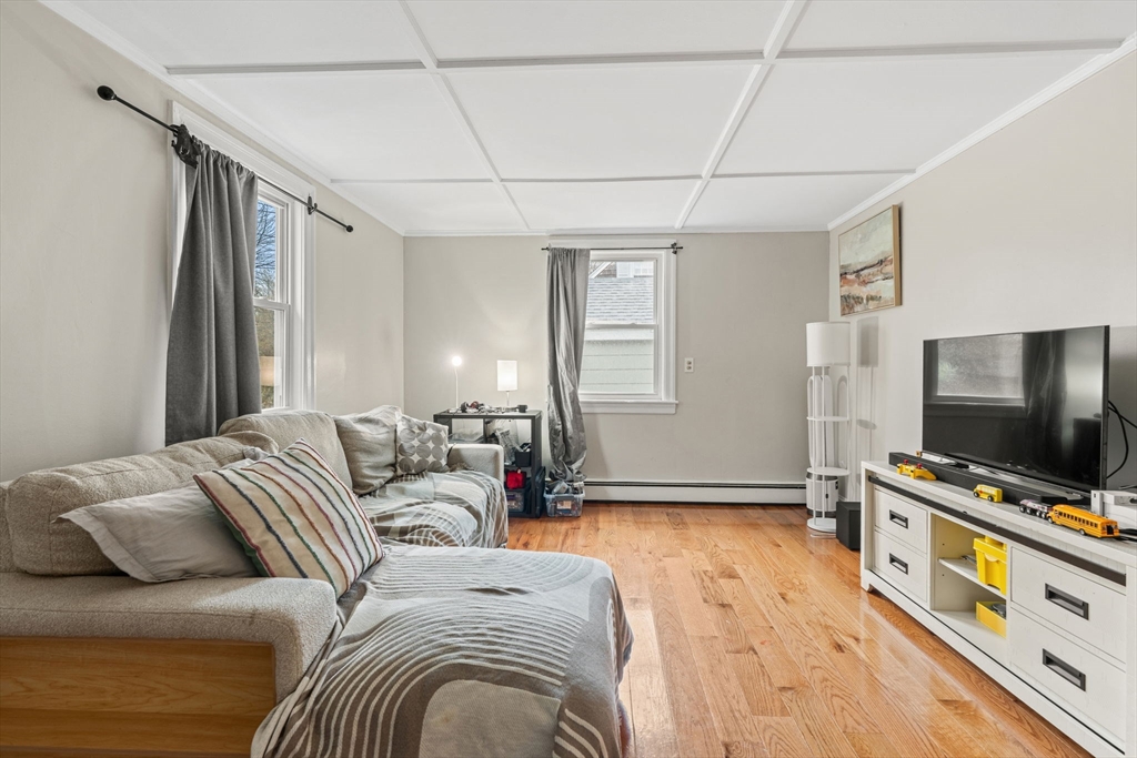 19 Cedar Street Beverly, MA 01915 - Photo 7 of 33 a bedroom with furniture and a flat screen tv