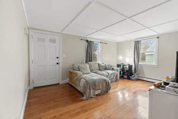 a living room with a bed furniture and a window