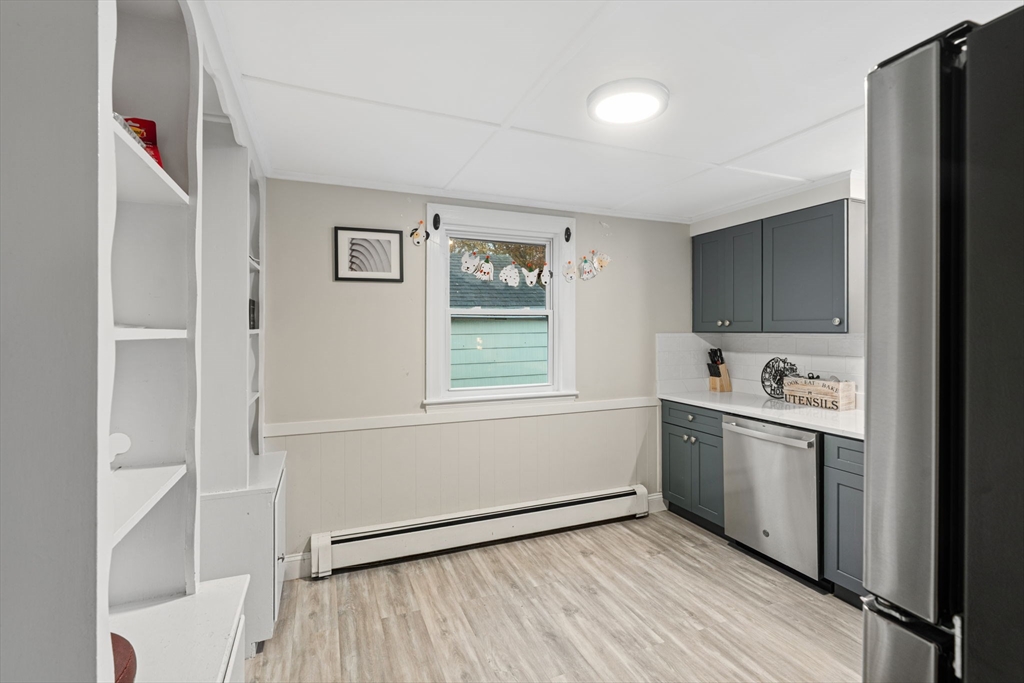 19 Cedar Street Beverly, MA 01915 - Photo 10 of 33 a kitchen with stainless steel appliances granite countertop a refrigerator and a sink