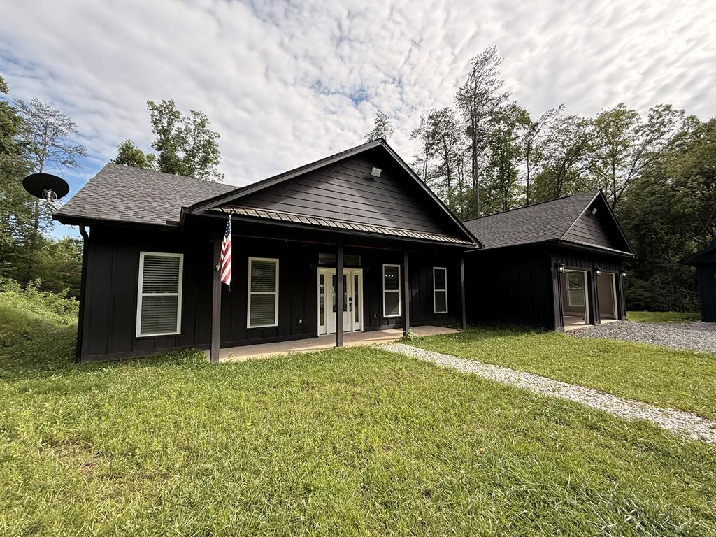 a front view of a house with a garden