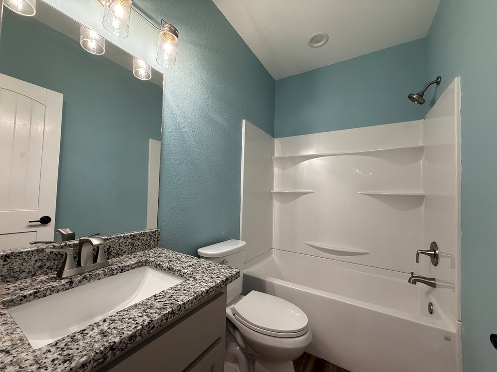 415 Autumn Ridge Drive Mineral Bluff, GA 30559 - Photo 12 of 21 a bathroom with a granite countertop sink a toilet and shower