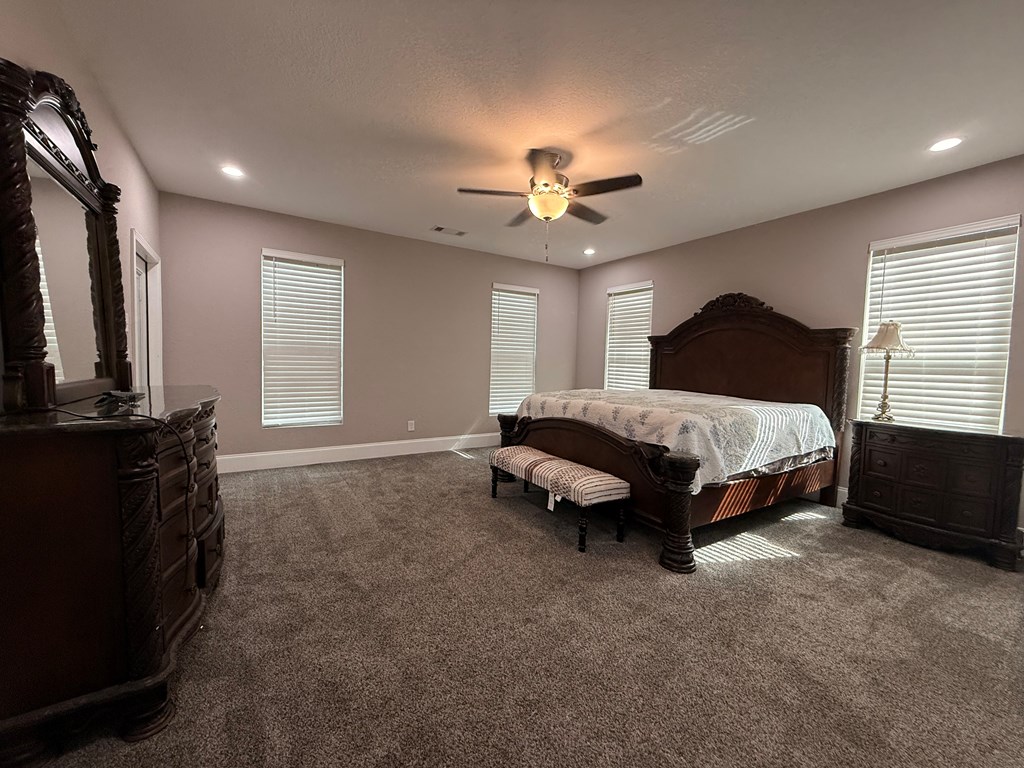 415 Autumn Ridge Drive Mineral Bluff, GA 30559 - Photo 14 of 21 a spacious bedroom with a bed and a chandelier