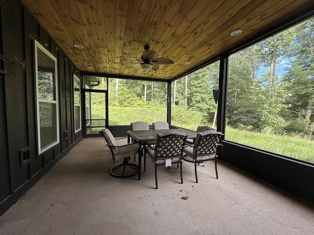 a dining room with furniture water view and garden view