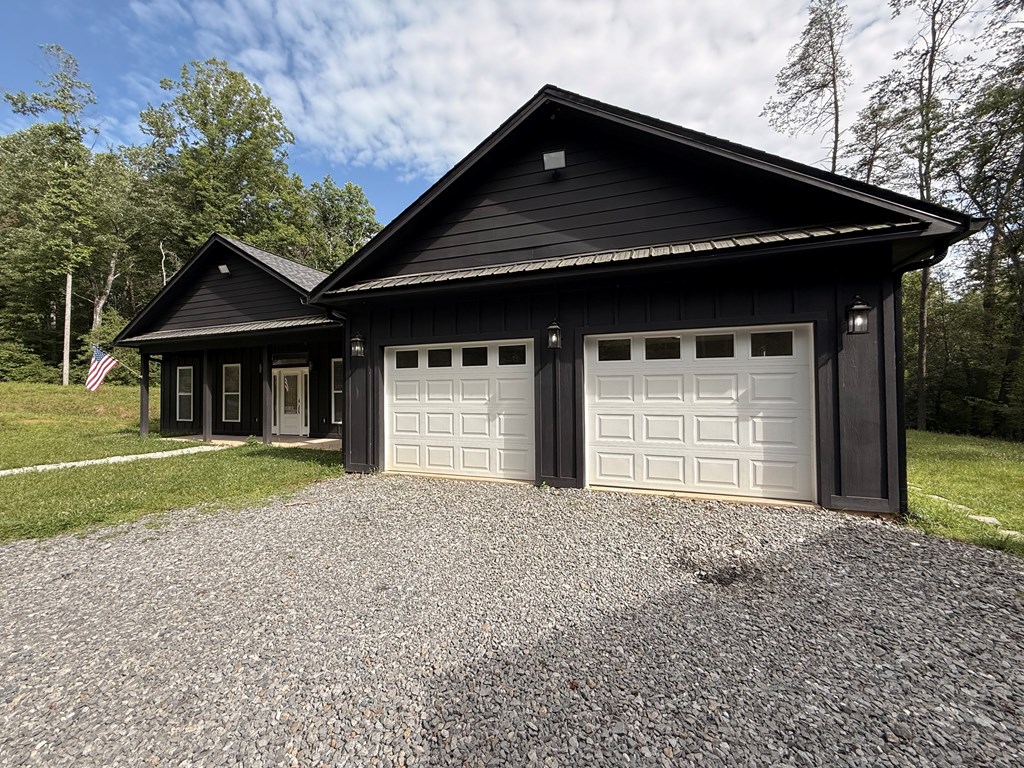 415 Autumn Ridge Drive Mineral Bluff, GA 30559 - Photo 2 of 21 a front view of a house with a yard and garage