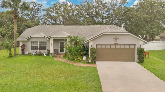 a front view of a house with a garden and yard