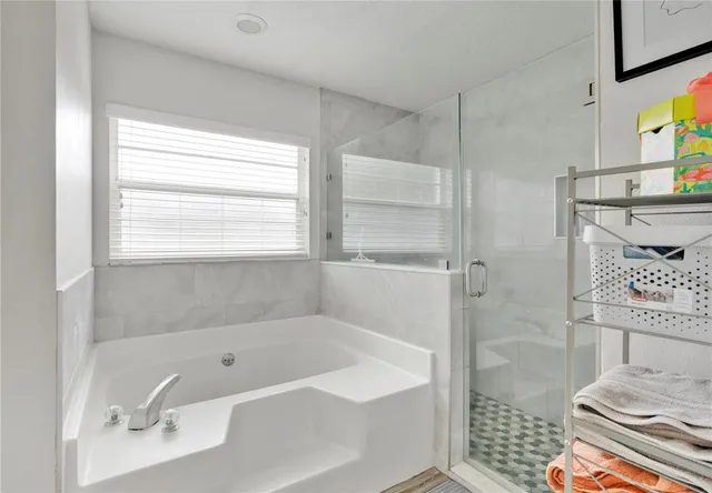 a bathroom with a bathtub and a shower