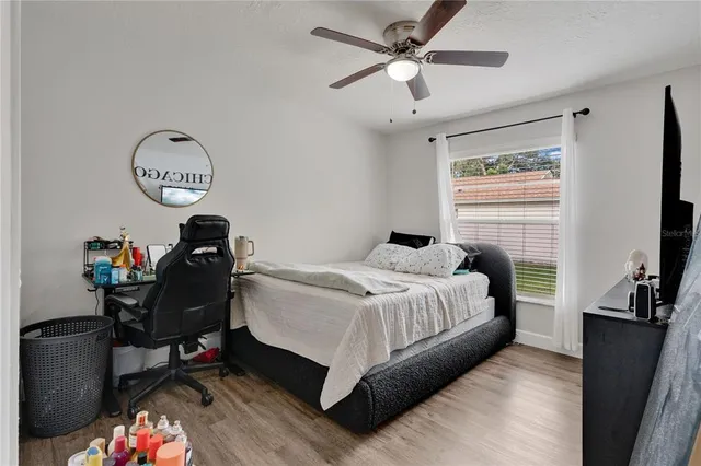 a bedroom with a bed and a chandelier