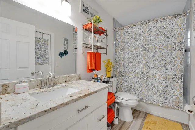 a bathroom with a sink toilet and shower