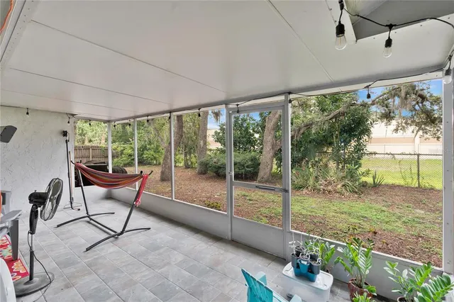 a view of a big room with furniture wooden floor and garden view