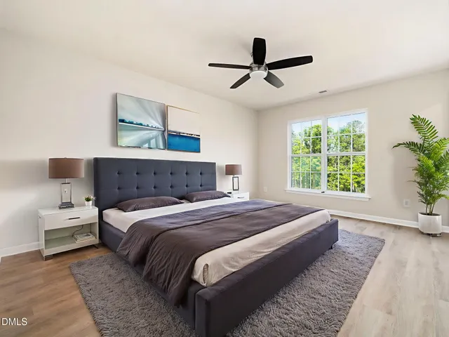 a bedroom with a large bed and a large window