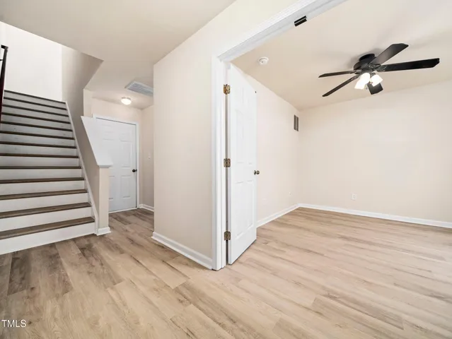 a view of a livingroom with wooden floor and window