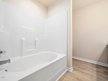 a white bath tub sitting next to a white sink