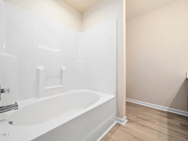 a white bath tub sitting next to a white sink