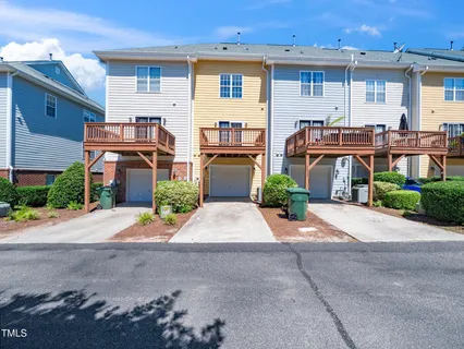 a front view of a house with a yard and a garage