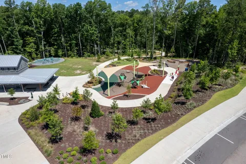 an aerial view of a house with garden space and street view