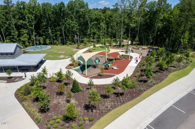 an aerial view of a house with garden space and street view