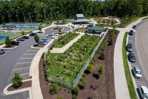 an aerial view of a house with a yard basket ball court and outdoor seating