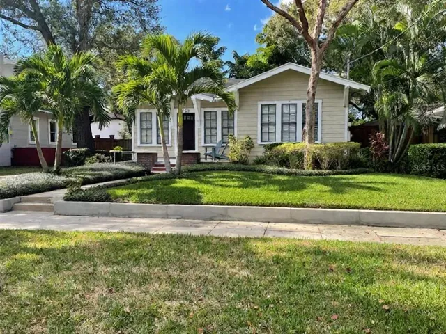 a front view of a house with a yard garage and outdoor seating