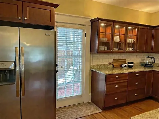 a kitchen with a refrigerator and a stove top oven