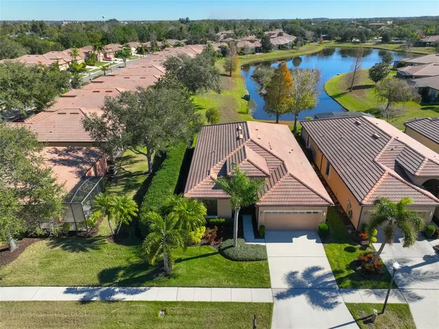 an aerial view of a house with garden space and lake view