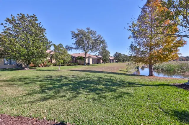 a sign board with a small yard and palm trees