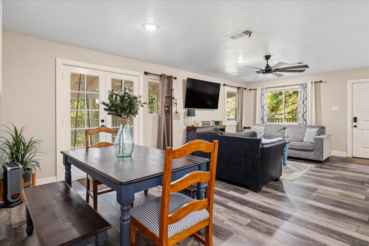 50740 Chu Ranch Road Oakhurst, CA 93644 - Photo 13 of 37 a living room with furniture a flat screen tv and a large window