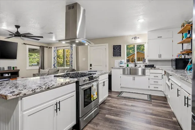 a bathroom with a granite countertop sink a toilet and shower