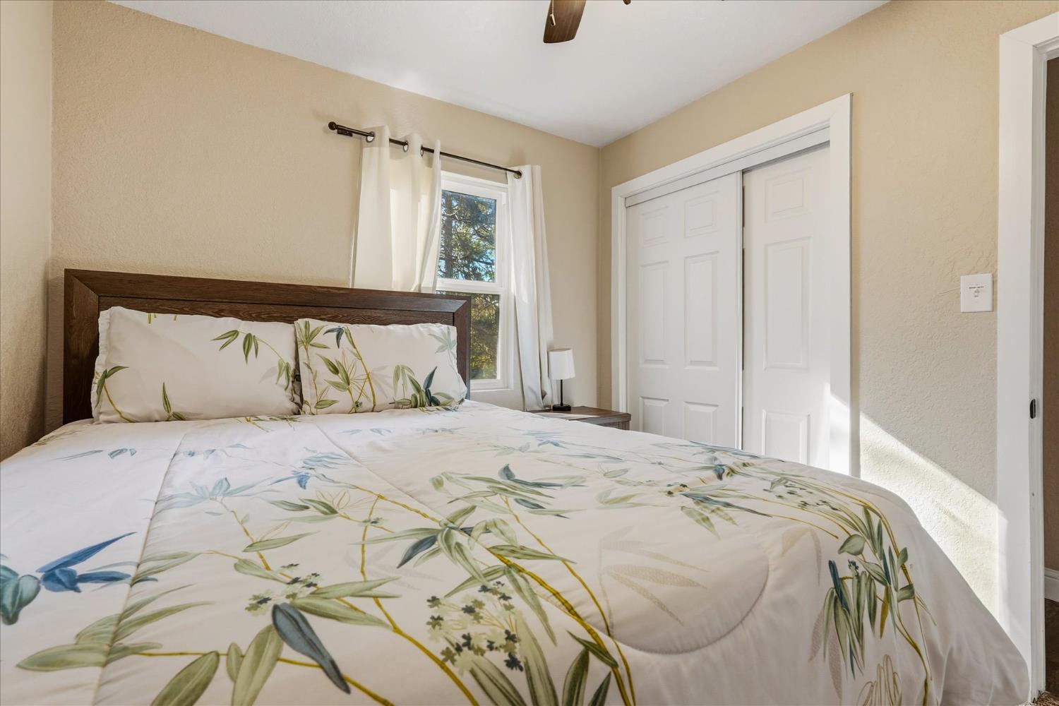 50740 Chu Ranch Road Oakhurst, CA 93644 - Photo 21 of 37 a bedroom with a bed and a window
