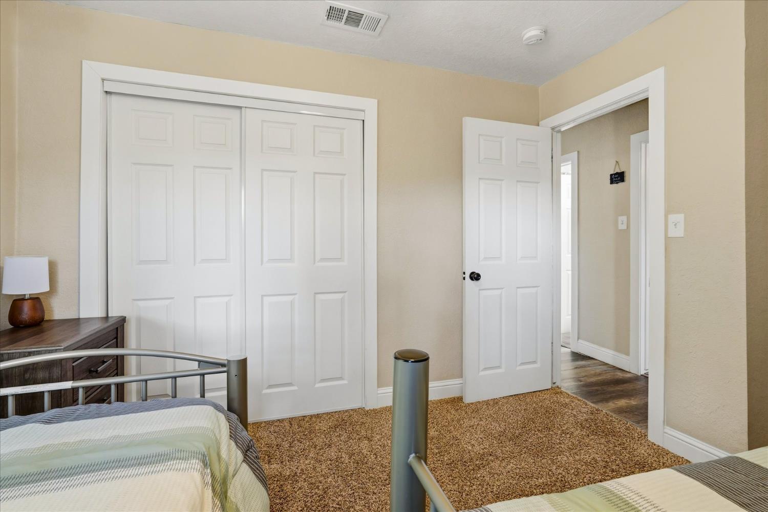 50740 Chu Ranch Road Oakhurst, CA 93644 - Photo 23 of 37 a bedroom with a bed and wooden floor