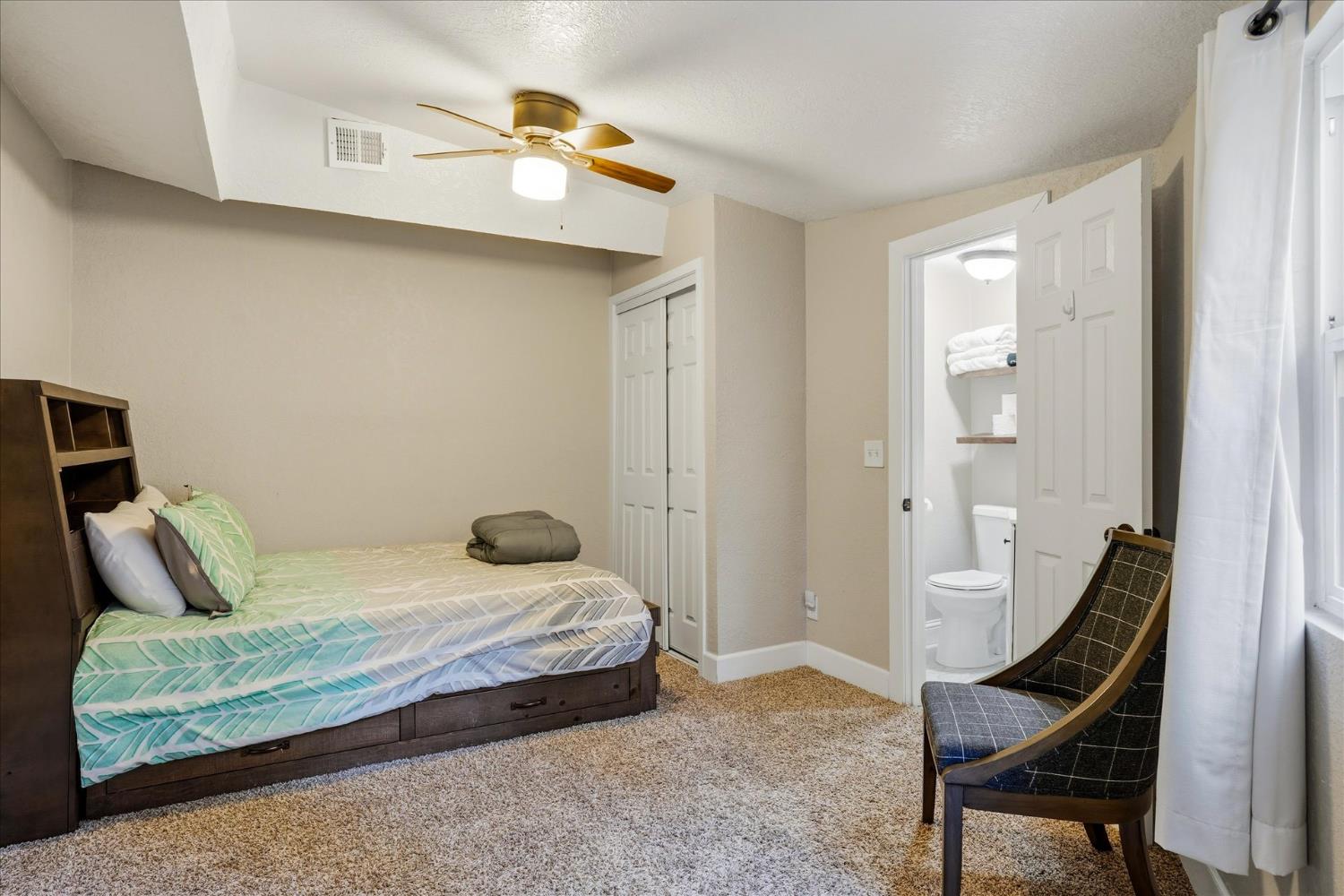 50740 Chu Ranch Road Oakhurst, CA 93644 - Photo 27 of 37 a bedroom with a bed and wooden floor