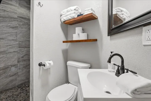 a bedroom with a bed and a flat tv screen