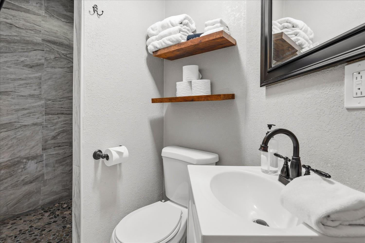 50740 Chu Ranch Road Oakhurst, CA 93644 - Photo 29 of 37 a bathroom with a toilet sink and mirror