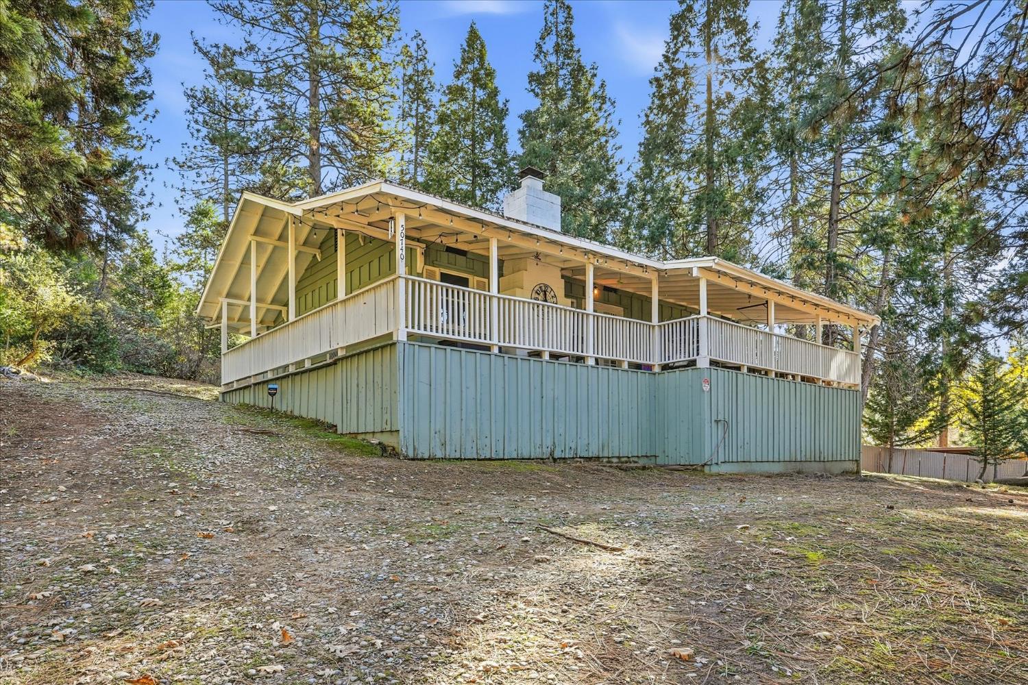 50740 Chu Ranch Road Oakhurst, CA 93644 - Photo 4 of 37 a view of a house with a yard