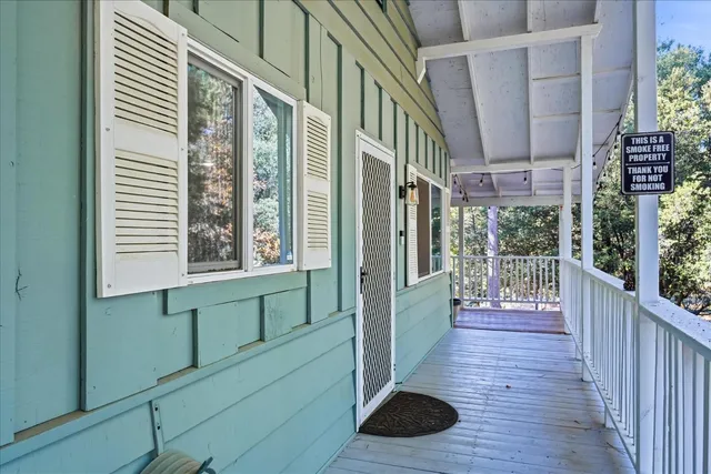 a view of a porch with wooden floor and stairs
