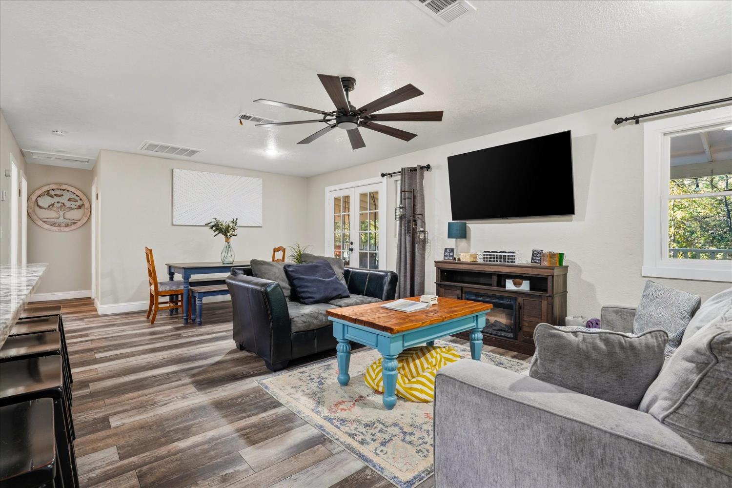 50740 Chu Ranch Road Oakhurst, CA 93644 - Photo 10 of 37 a living room with furniture and a flat screen tv