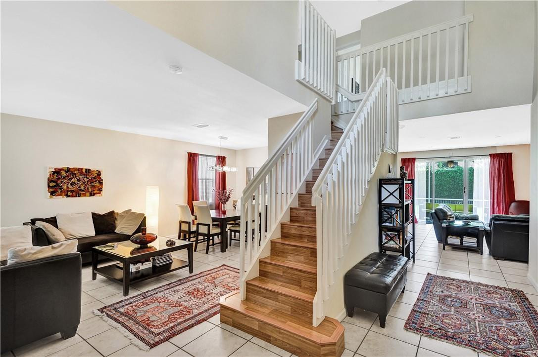 4366 Laurel Ridge Circle Weston, FL 33331 - Photo 17 of 64 a living room with furniture floor to ceiling window and a rug