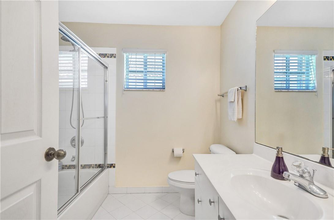 4366 Laurel Ridge Circle Weston, FL 33331 - Photo 54 of 64 a bathroom with a sink a toilet and shower