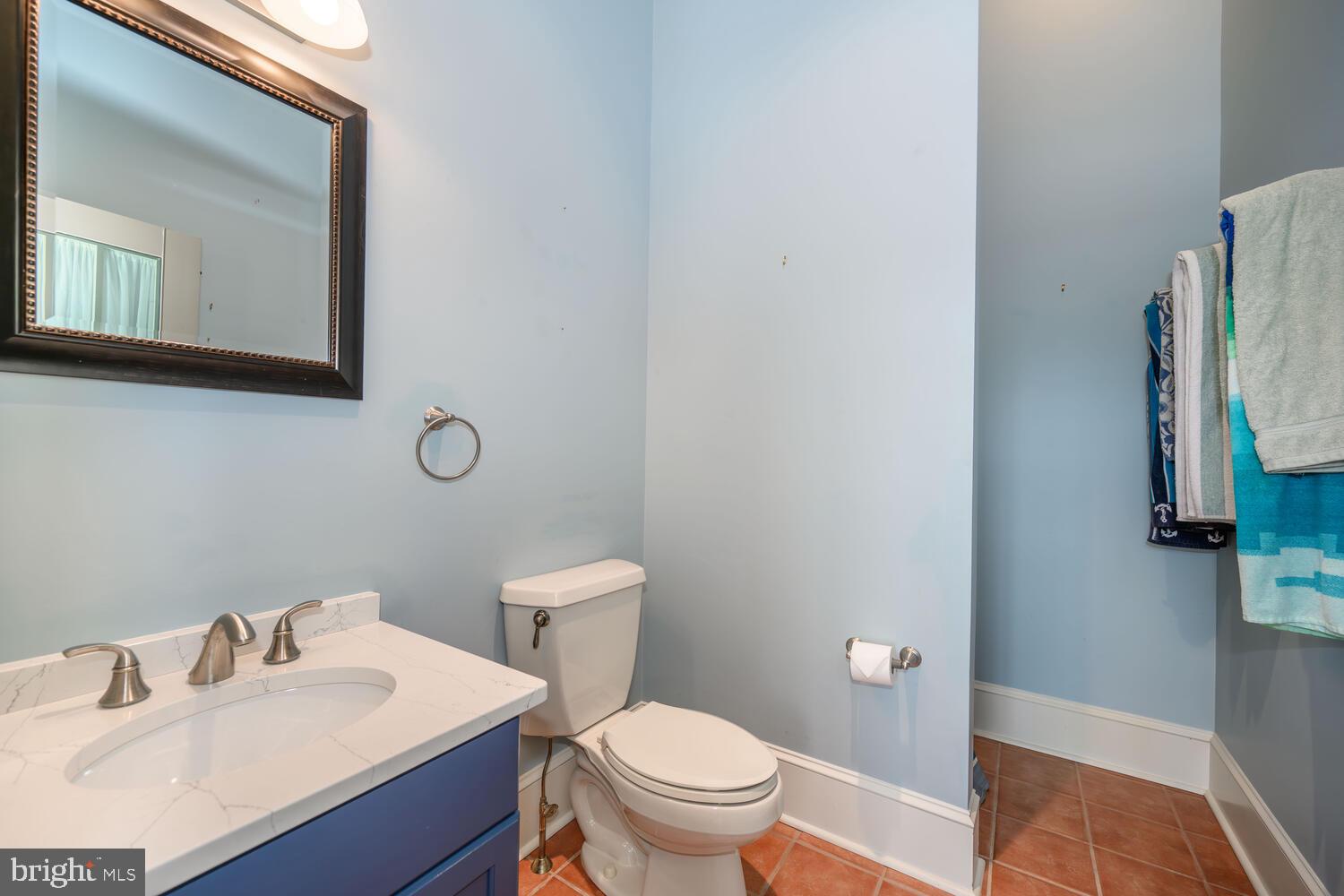 23961 Lynnewood Drive St. Michaels, MD 21663 - Photo 33 of 81 a bathroom with a toilet sink vanity and mirror