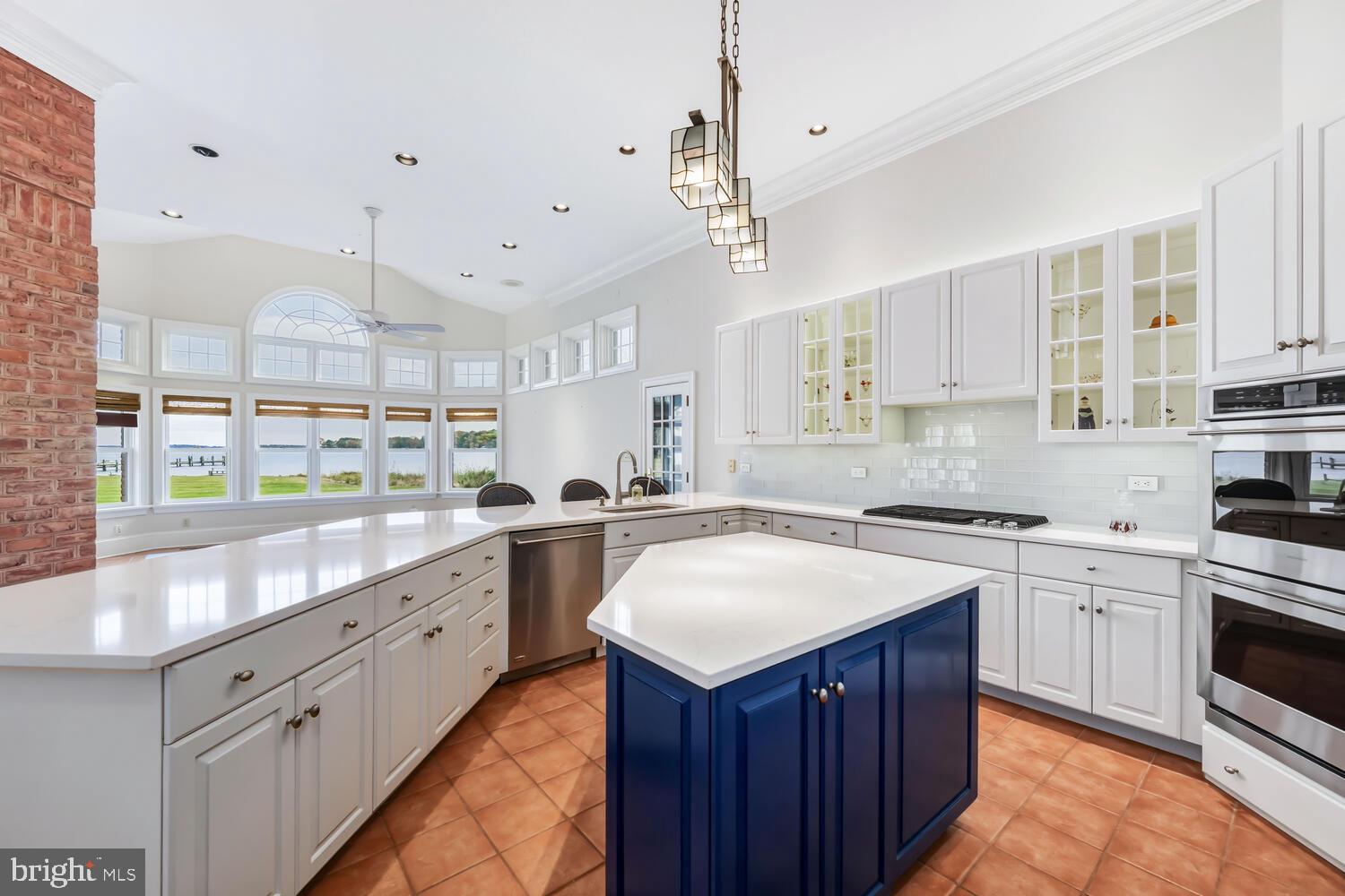 23961 Lynnewood Drive St. Michaels, MD 21663 - Photo 36 of 81 a kitchen with kitchen island granite countertop a sink counter top space and stainless steel appliances