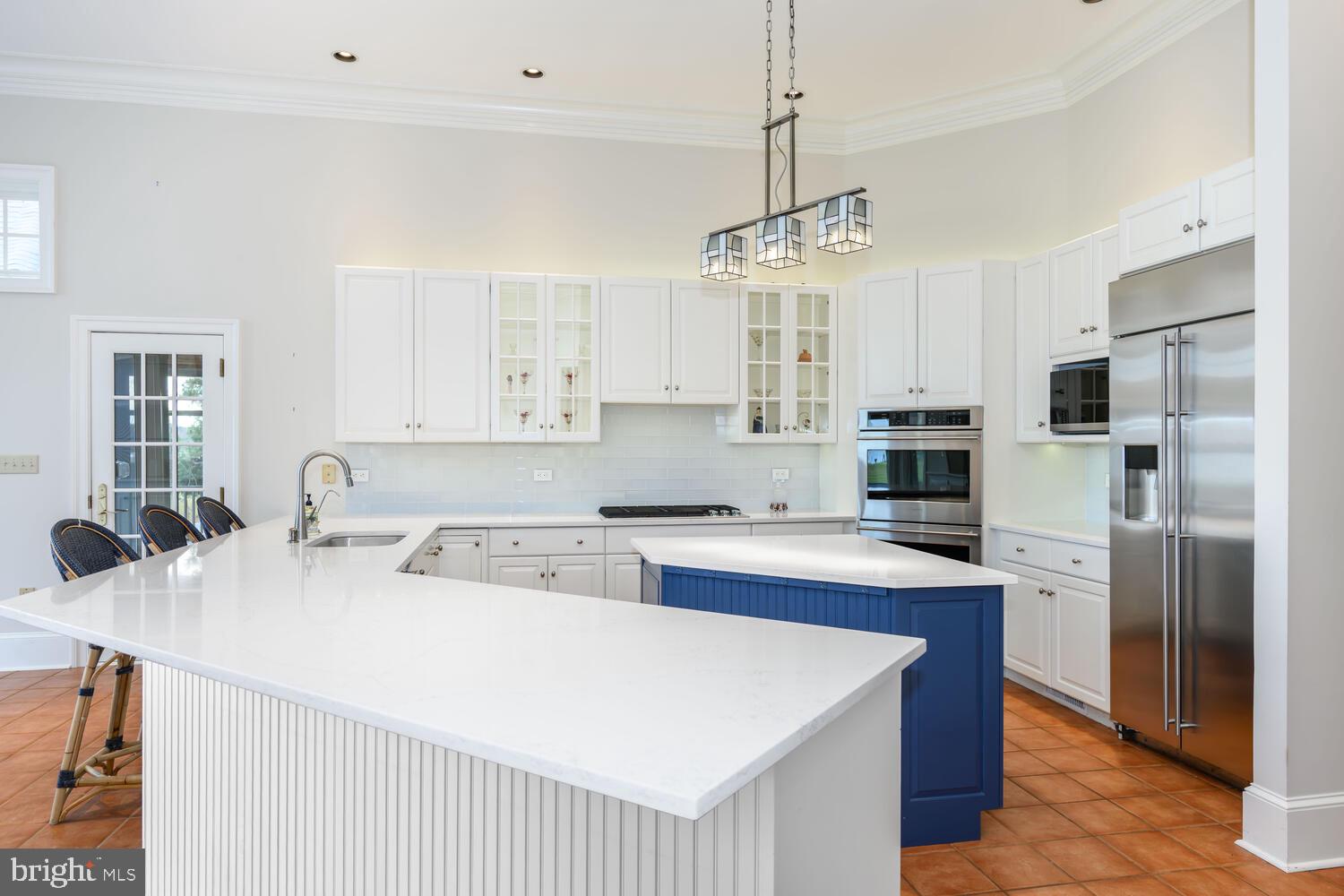 23961 Lynnewood Drive St. Michaels, MD 21663 - Photo 37 of 81 a kitchen with stainless steel appliances kitchen island granite countertop a sink stove and refrigerator