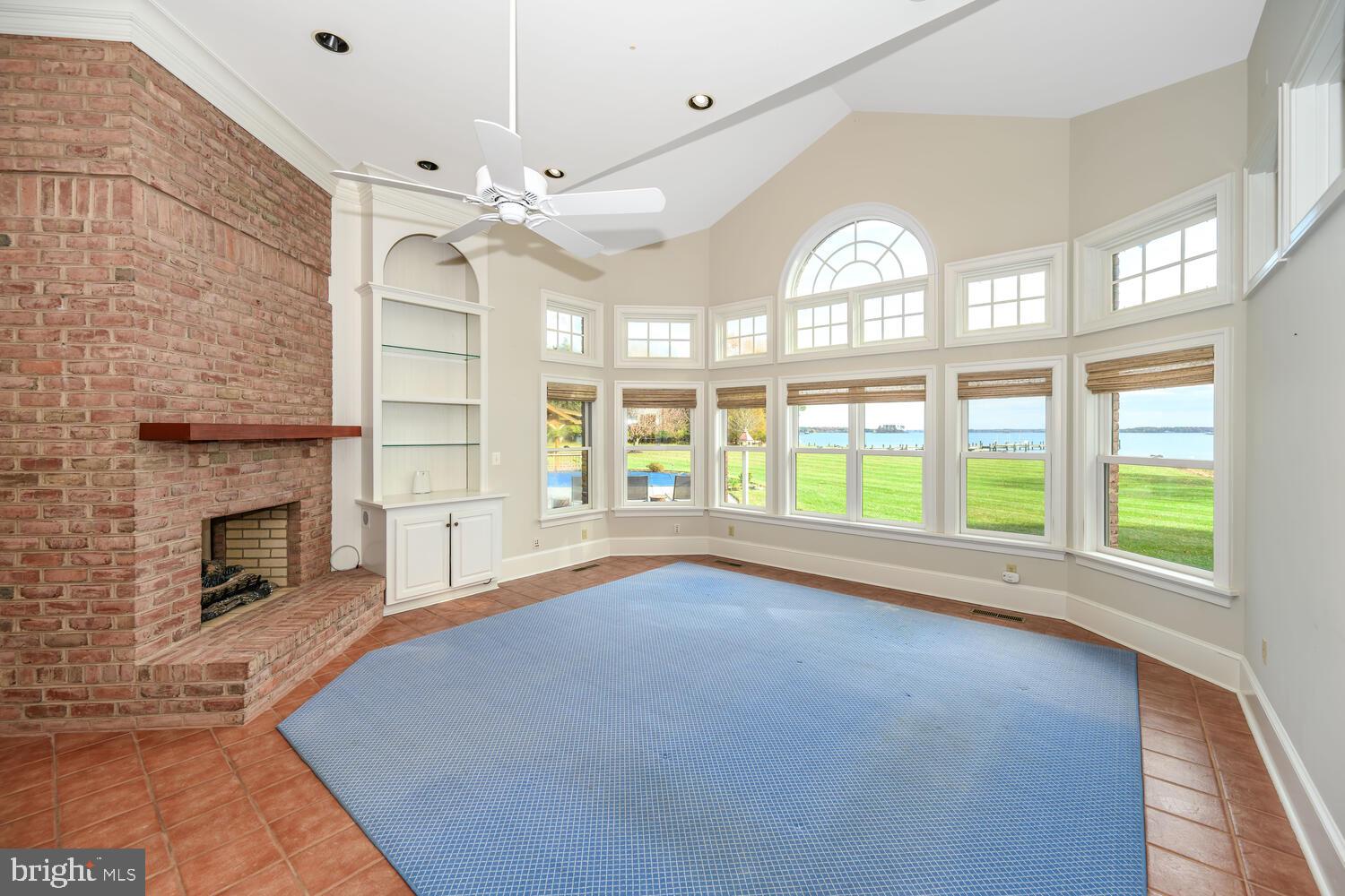 23961 Lynnewood Drive St. Michaels, MD 21663 - Photo 38 of 81 a view of an empty room with a fireplace and a large window
