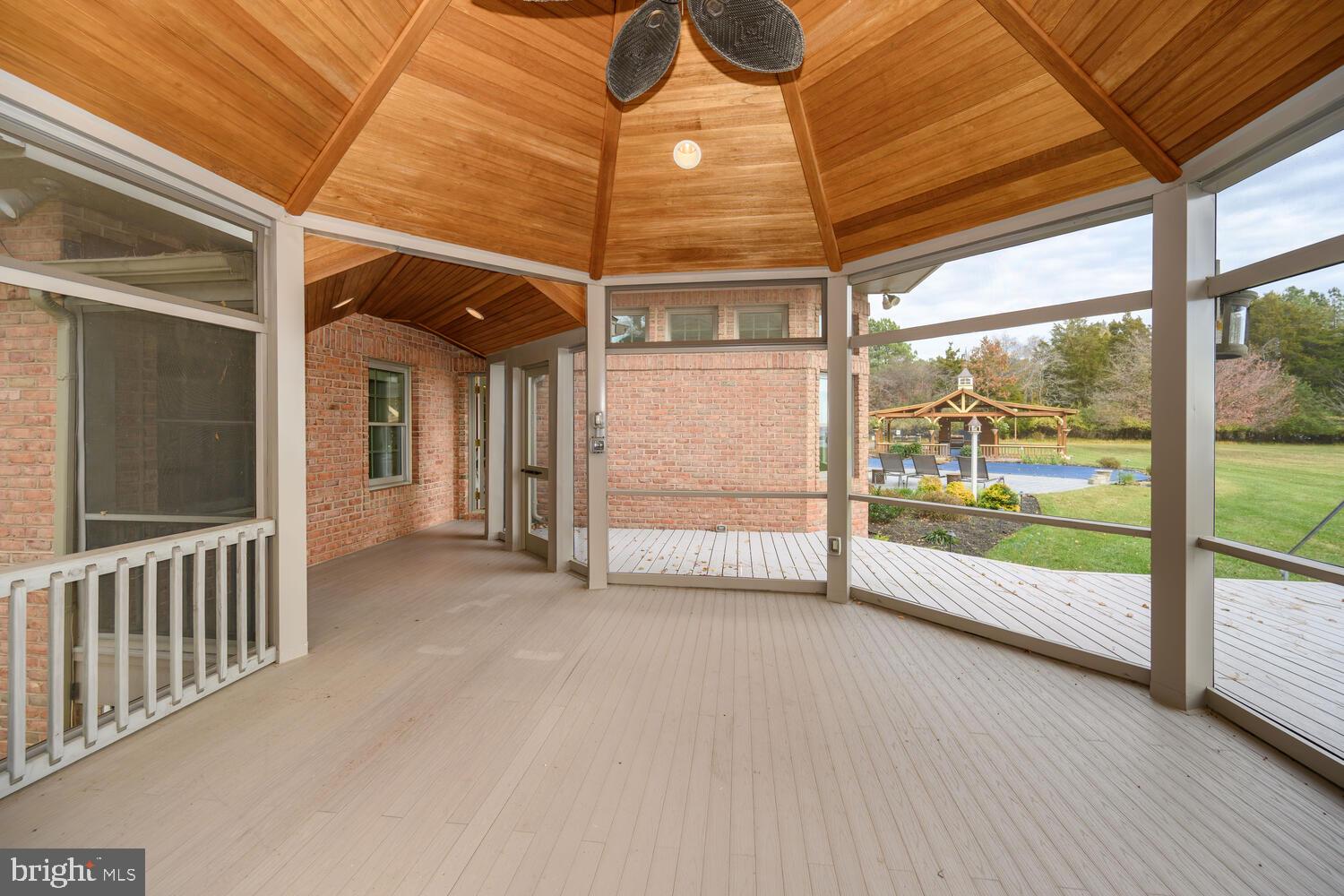 23961 Lynnewood Drive St. Michaels, MD 21663 - Photo 41 of 81 a view of a porch with wooden floor and stairs