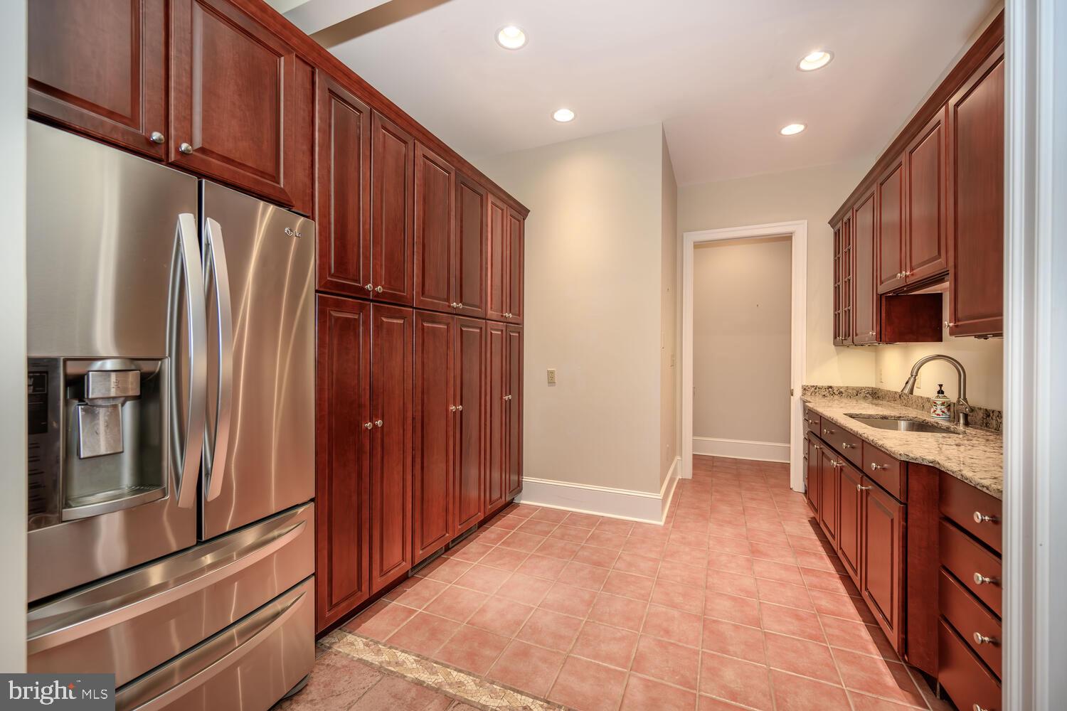 23961 Lynnewood Drive St. Michaels, MD 21663 - Photo 44 of 81 a kitchen with stainless steel appliances granite countertop a refrigerator and a stove