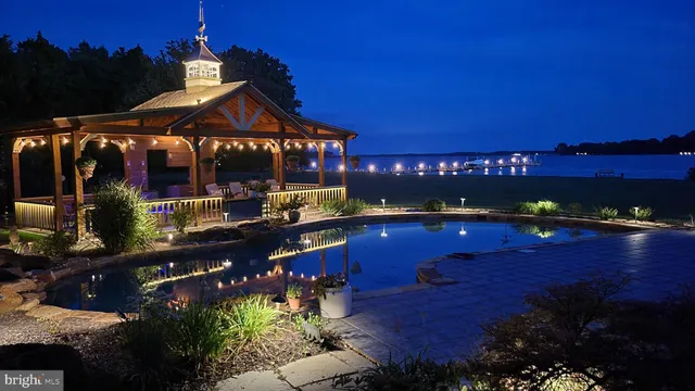 an aerial view of a house with a yard and lake view